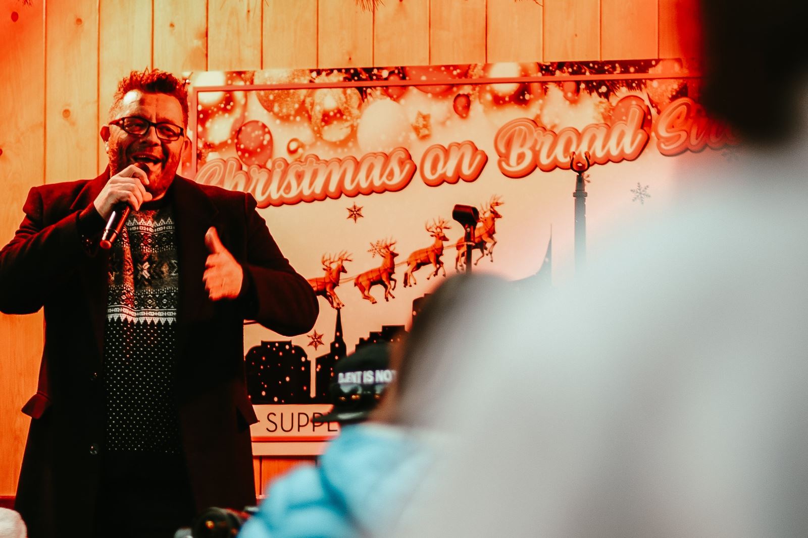 Man singing on festive stage